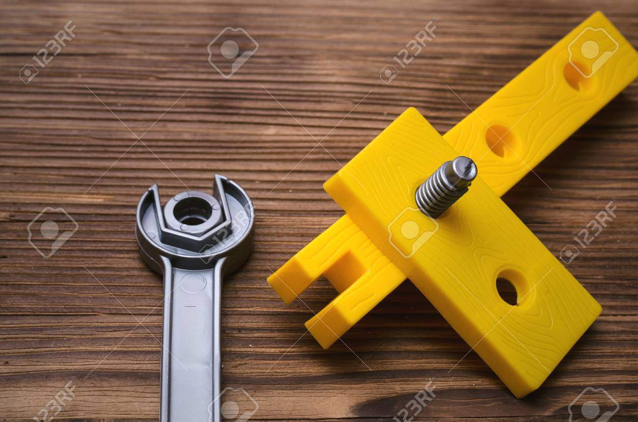 construction background wrench and wood units bonding building elements